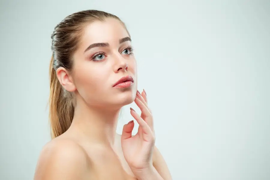 A woman with naturally enhanced lips after Juvedérm® filler, looking radiant and confident. A professional injector performing a lip filler treatment in a clean, modern medispa setting.
